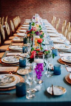 a long table set with plates and place settings