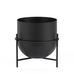 a black bowl sitting on top of a metal stand