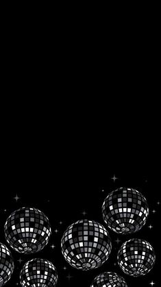 a group of disco balls sitting on top of a black floor