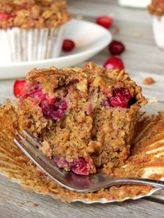 a close up of a muffin on a plate with a fork