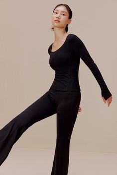 Let every motion flow as easy as your breath in this Ballet Longsleeve T-Shirt - tailored in a flexible, breathable blend to support & enhance your movement as you go through your dance or workout routine. This item is FINAL SALE and cannot be returned or exchanged. Details Materials & Care Shipping & Returns • Slim-fitting, comfortable, yet minimalist-chic design.• Durable, breathable nylon-Spandex fabric blend.• Designed for ballet/dance, yoga, or any activity. • Materials: 81% nylon, 19% Span Four-way Stretch Top With Thumbholes, Black 4-way Stretch Elastane Tops, Functional Elastane Tops For Yoga, Yoga Tops Made Of Elastane, Compressive Elastane Tops For Yoga, Versatile Black Top With 4-way Stretch, Versatile Black 4-way Stretch Top, Moisture-wicking Elastane Top For Yoga, Moisture-wicking Elastane Yoga Tops