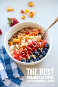 a bowl filled with cereal and fruit on top of a table