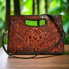 This rustic hand-tooled leather purse, featuring a stunning chiseled artisan design, adds a touch of vintage elegance to your daily ensemble. Ideal for carrying all your essentials, this purse is handcrafted with love and care by skilled artisans, offering a unique rustic charm rarely found in stores.  With exquisite chiseling on both sides, it makes the perfect gift for her on special occasions.  Measures: 🌹height: 20cm. 8  inch 🌹width : 29 cm.  11.4inch 🌹base:4 cm.    1.5 inch Large  adjust Brown Engraved Bags For Everyday Use, Engraved Brown Bags For Everyday Use, Rectangular Engraved Shoulder Bag, Artisan Engraved Shoulder Bag For Everyday, Artisan Shoulder Bag With Engraving For Everyday Use, Artisan Shoulder Bag With Engraved Details For Everyday Use, Artisan Engraved Rectangular Bag, Artisan Rectangular Engraved Bag, Artisan Rectangular Engraved Bags