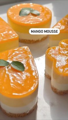 several desserts are arranged on a plate with the words mango mousse above them