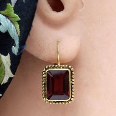 Derived from the table cut in the 16th century, the emerald cut was a popular manner in which to facets emerald, diamond and garnet stones as the straight edges were not prone to the chipping which commonly plagued more intricate stone-cuts. 14k solid gold paired with faceted garnet stone and granulated edge. French backs for pierced ears. Size: 3/4 Inch. Lapis Earrings, Big Jewelry, Garnet Necklace, Straight Edges, Cluster Necklace, Garnet Earrings, Pretty Necklaces, Cubic Zirconia Earrings, Garnet Stone