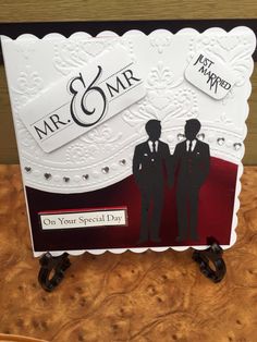 a card with two men in suits on it, and the words mr and mrs are cut out