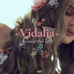 a woman with flowers in her hair and the words vidala wonderful life on it