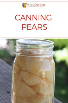 a jar filled with sliced bananas sitting on top of a wooden table