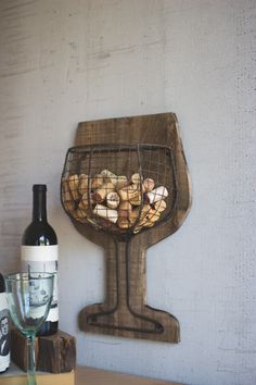 a bottle of wine and some corks in a basket on top of a table