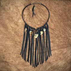 "-This dramatic bib necklace features soft black deerskin leather and beautiful raw citrine stones. -Vintage brass chains peek out from the leather fringe. -Citrine stones range 1\" to 1.25\" from top to bottom. -Perfect necklace for Halloween! -The collar is adjustable from 15\" - 17\" with a 2\" adjuster chain in the back. Longer adjuster chain available by request. -Leather fringe and chains hang 7\" from the collar. -Designed and handmade in South Pasadena, CA. -ONE OF A KIND! Check out more Bohemian Black Leather Necklace, Bohemian Hand Forged Necklaces For Festivals, Raw Citrine Necklace, Leather Statement Necklace, Witchy Necklace, Dramatic Necklace, Black Statement Earrings, Repurposed Necklace, Raw Citrine