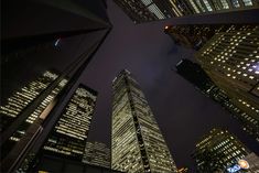 skyscrapers lit up at night in the city