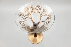 a glass bowl with a tree painted on it