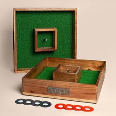 an open wooden box with scissors and other items