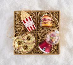 a box filled with donuts, candy and other items on top of a table