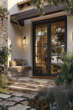 an outdoor living area with steps leading up to the front door and sitting area on the side of the house