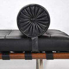 a black leather chair with an ottoman on it