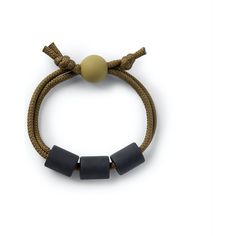 a bracelet with two grey beads on it