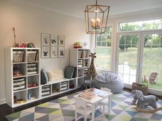 a living room filled with lots of furniture and decor on top of a checkered floor