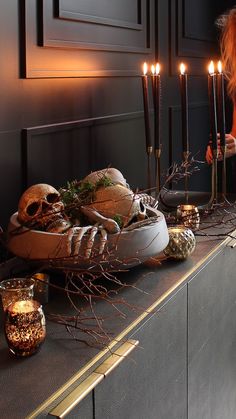 a table with candles and skulls on it