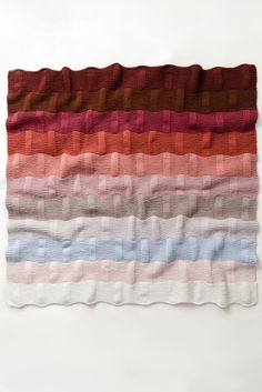 a multicolored blanket on a white background