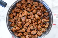 a pan filled with cooked meat on top of a table