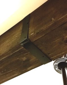 a close up view of the corner of a wooden ceiling