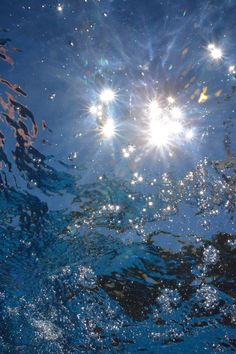 the sun shines brightly in the blue water