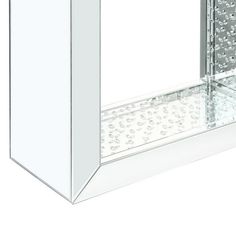 a bathroom medicine cabinet with clear glass doors and silver hardware on the bottom shelf,