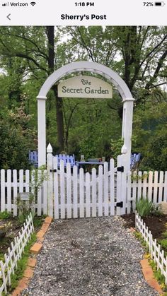 a white picket fence with a sign that says secret garden