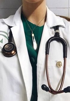 a woman wearing a white coat with a stethoscope on her chest