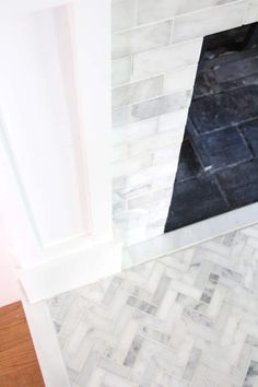 a bathroom with a tiled floor and white walls