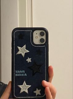 someone is holding up their phone case with stars on it