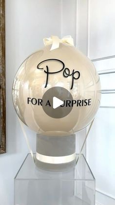 a glass ball with the words pop for a surprise on it