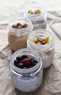 four jars filled with food sitting on top of a piece of paper next to each other