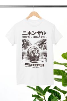 About The Design: Discover serenity with this illustration featuring a Japanese Macaque Monkey enjoying a soothing hot spring soak. This piece captures the tranquility of wildlife in harmony with nature, offering a peaceful addition to any space. Dive into the serene world of the macaque and embrace the beauty of natural relaxation. Specifications: * 100% combed and ring-spun cotton * Lightweight fabric (4.2 oz/yd² (142 g/m * Retail fit, side-seamed * Tear-away label * Ribbed knit collar with se White Harajuku Style Screen Print Shirt, White Harajuku Shirt With Screen Print, Japanese Macaque, Macaque Monkey, Japanese Hot Springs, Harajuku Shirt, Monkey Shirt, Japanese Shirt, Aesthetic Shirt