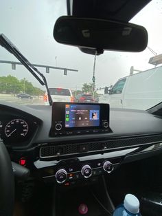 a car dashboard with an electronic device in the center