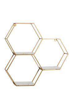 three hexagonal shelves with gold metal frames