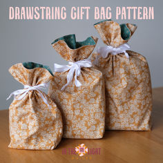 three drawstring gift bag patterns on a table with text overlay that reads, drawstring gift bag pattern