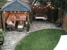 an outdoor patio with seating and string lights