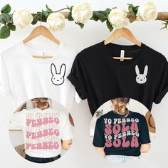 three t - shirts with bunny ears on them hanging from clothes racks next to white roses