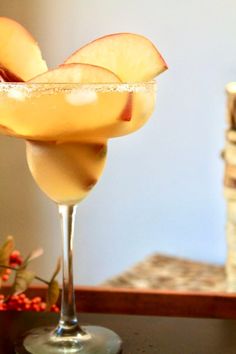 an apple cider is garnished with sugar and sits on a table next to a stack of books