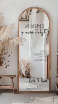 a mirror sitting on top of a white floor next to a wooden bench and potted plant