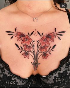 a woman's chest with red flowers on it