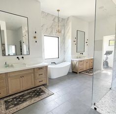 a large bathroom with two sinks and a bathtub