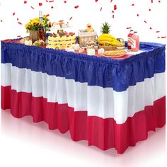 a table covered in food and confetti with red, white, and blue colors