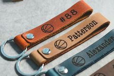 two leather keychains with personalized numbers on them