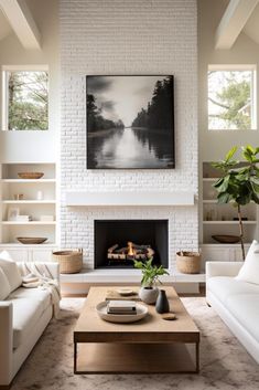 a living room filled with furniture and a fire place in front of a painting on the wall