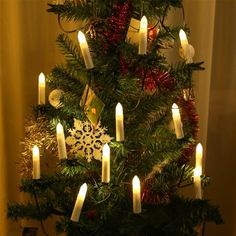 a christmas tree with lit candles on it