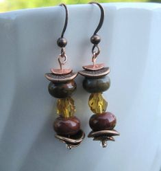 Earrings featuring the colors of Fall handmade with Red Creek Jasper beads, copper, antique copper, and Czech beads. This one inch drop earrings beautifully captures the colors of autumn with unique contrasting textures of stone, glass and metal.  The Fall colors of browns, reds and greens are captured in the semiprecious Red Creek Jasper stone and golden Czech fire polised beads. The vibrant rondelles colors are complimented by the antique copper spacers and the golden fire polished Czech glass Brown Copper Beaded Earrings For Gift, Gift Brown Copper Beaded Earrings, Bronze Copper Earrings With Dangling Beads, Bronze Round Bead Copper Earrings, Brown Copper Beaded Earrings, Bronze Copper Earrings With Round Beads, Bronze Copper Jewelry With Dangling Beads, Brown Copper Bead Earrings, Brown Copper Beaded Earrings With Dangling Beads