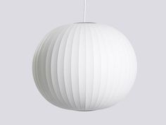 a white ball light hanging from the ceiling